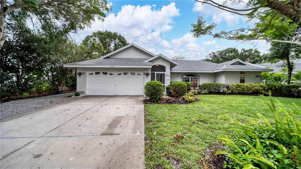 5219 Inverness Drive Sarasota, FL 34243 - Photo 30 of 32 a front view of a house with garden