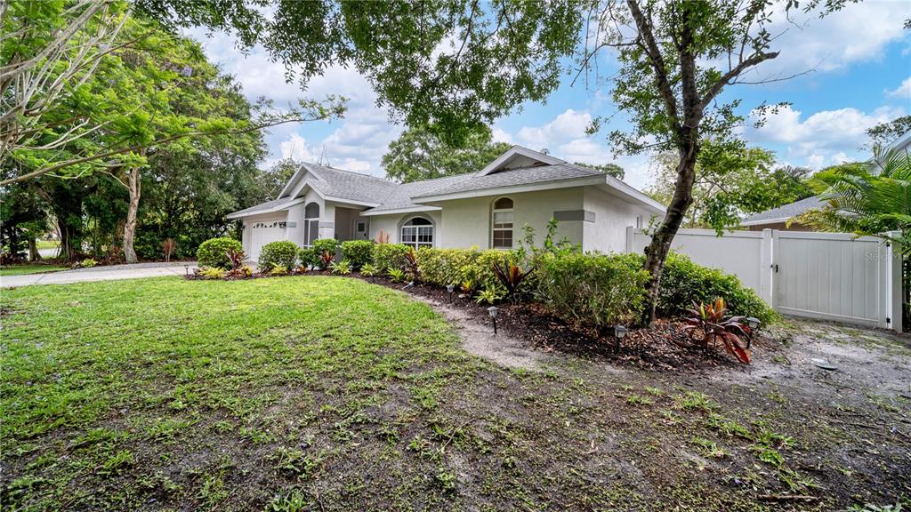 5219 Inverness Drive Sarasota, FL 34243 - Photo 31 of 32 a front view of house with yard and green space