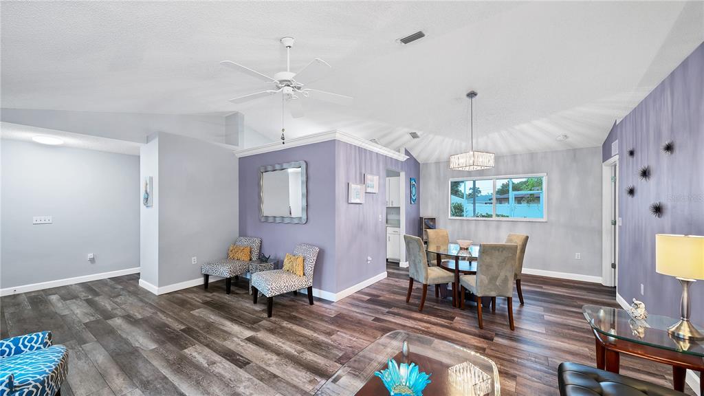 5219 Inverness Drive Sarasota, FL 34243 - Photo 7 of 32 a living room with furniture and a chandelier