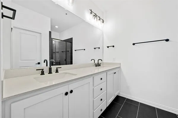 an empty room with a ceiling fan and a bathroom