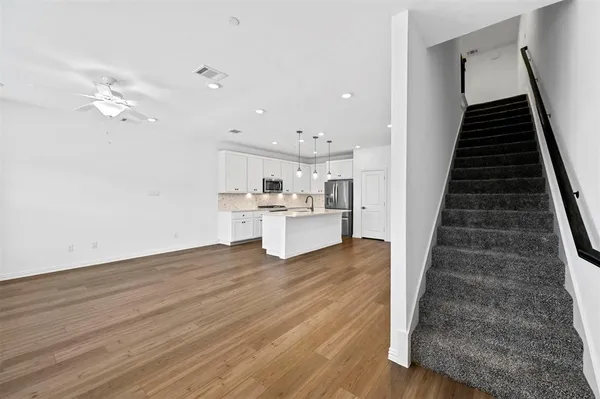 a view of kitchen with sink and refrigerator