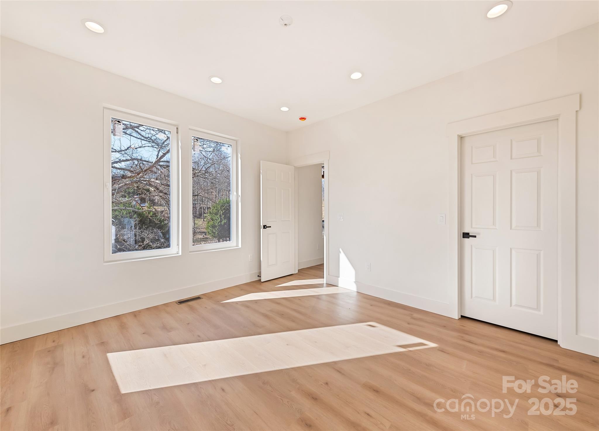 40 Firefly Ridge Trail Alexander, NC 28701 - Photo 14 of 33 a view of an empty room with wooden floor and a window