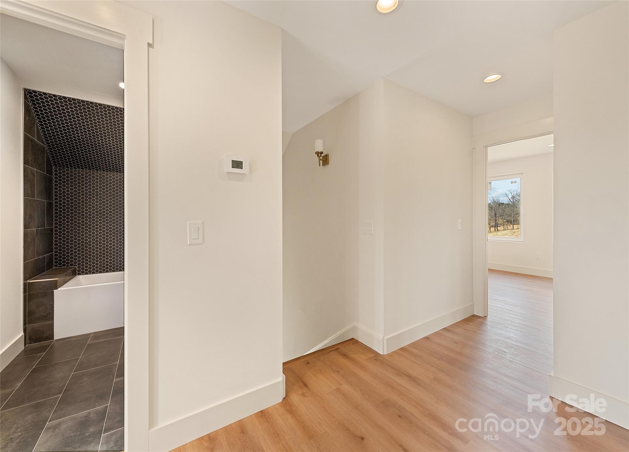 40 Firefly Ridge Trail Alexander, NC 28701 - Photo 20 of 33 a view of hallway with bathroom and wooden floor