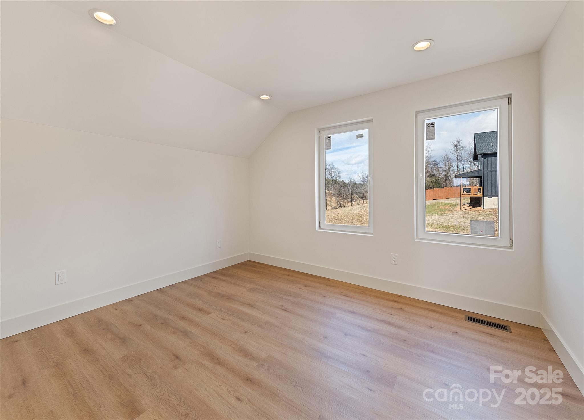 40 Firefly Ridge Trail Alexander, NC 28701 - Photo 21 of 33 an empty room with wooden floor and windows