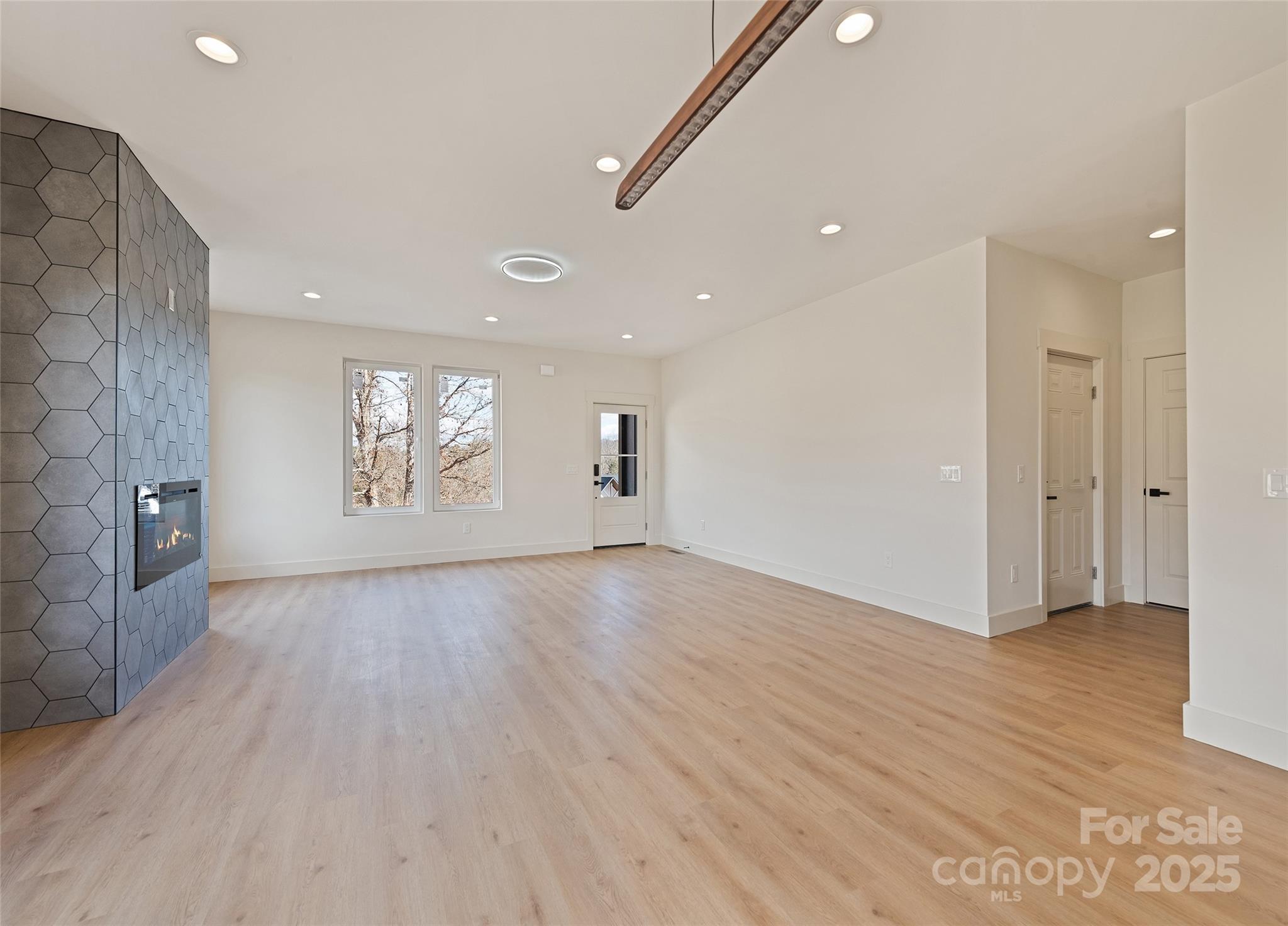 40 Firefly Ridge Trail Alexander, NC 28701 - Photo 5 of 33 a view of an empty room with windows and wooden floor