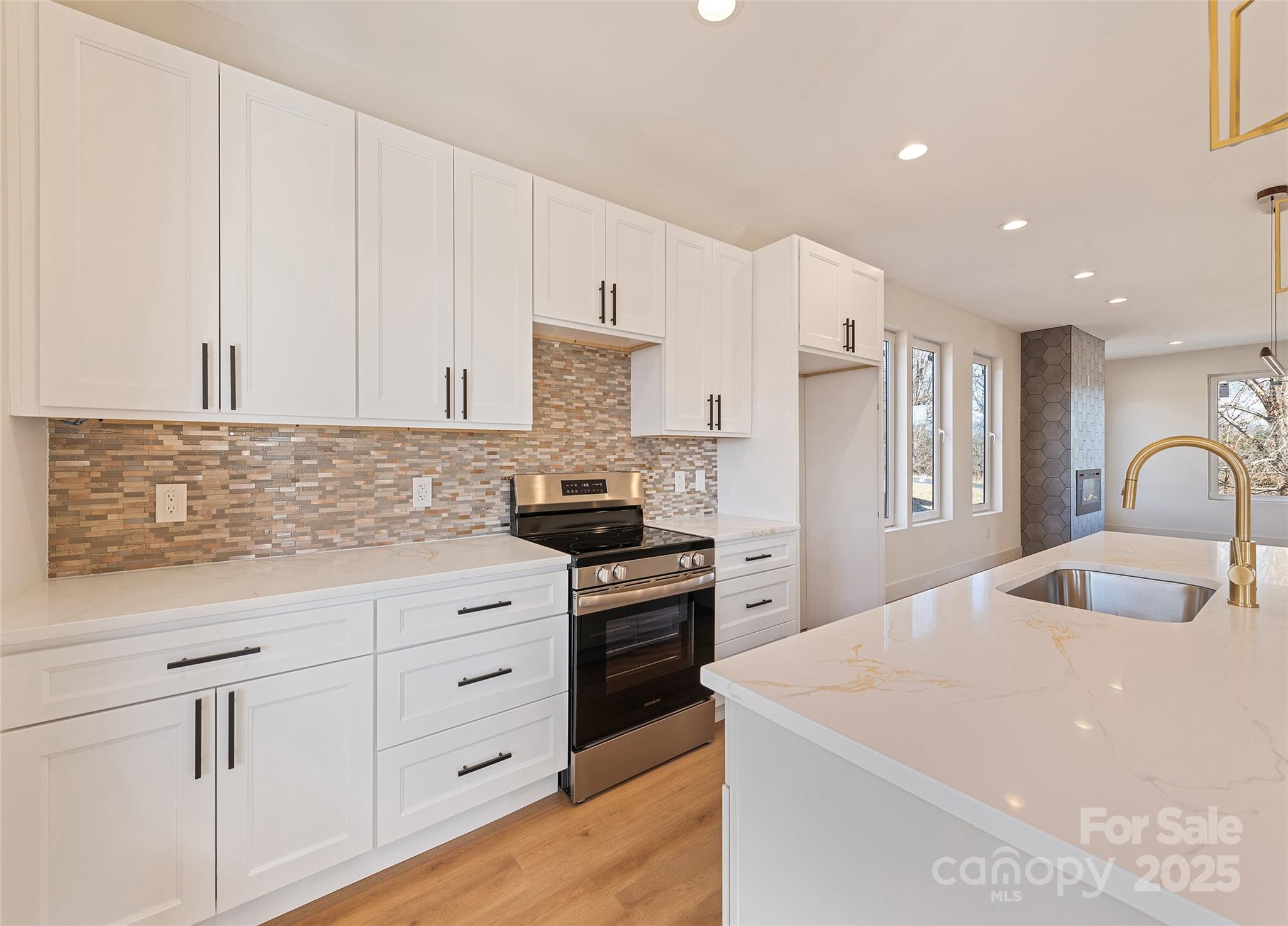 40 Firefly Ridge Trail Alexander, NC 28701 - Photo 7 of 33 a kitchen with granite countertop a sink stove and refrigerator