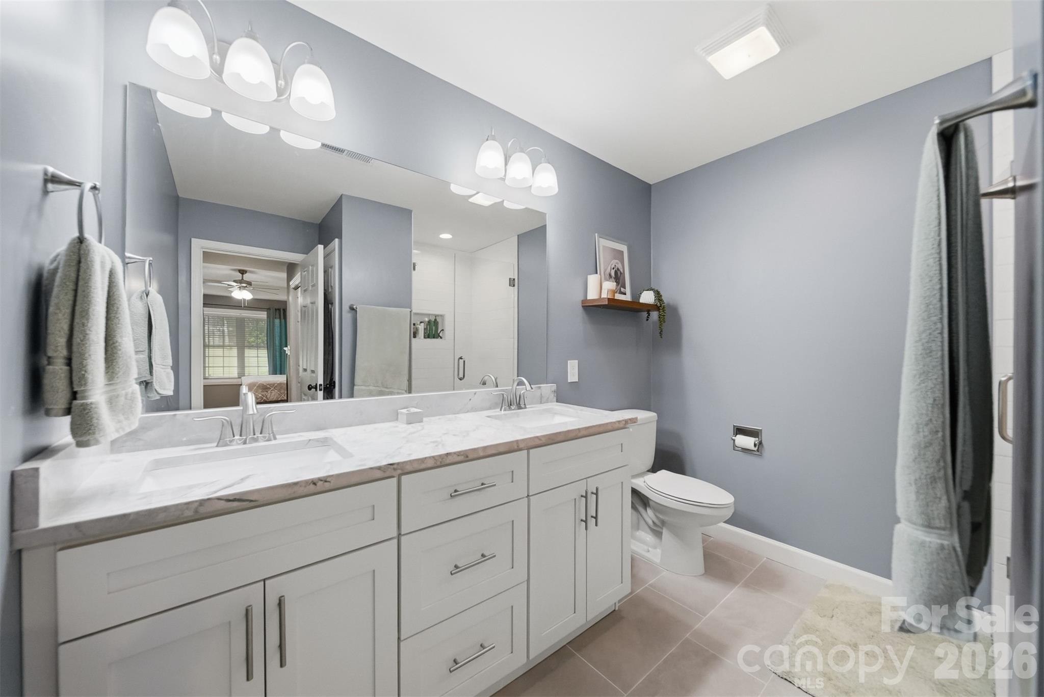 490 Dudley Shoals Road Granite Falls, NC 28630 - Photo 16 of 38 a bathroom with a double vanity sink toilet and a mirror
