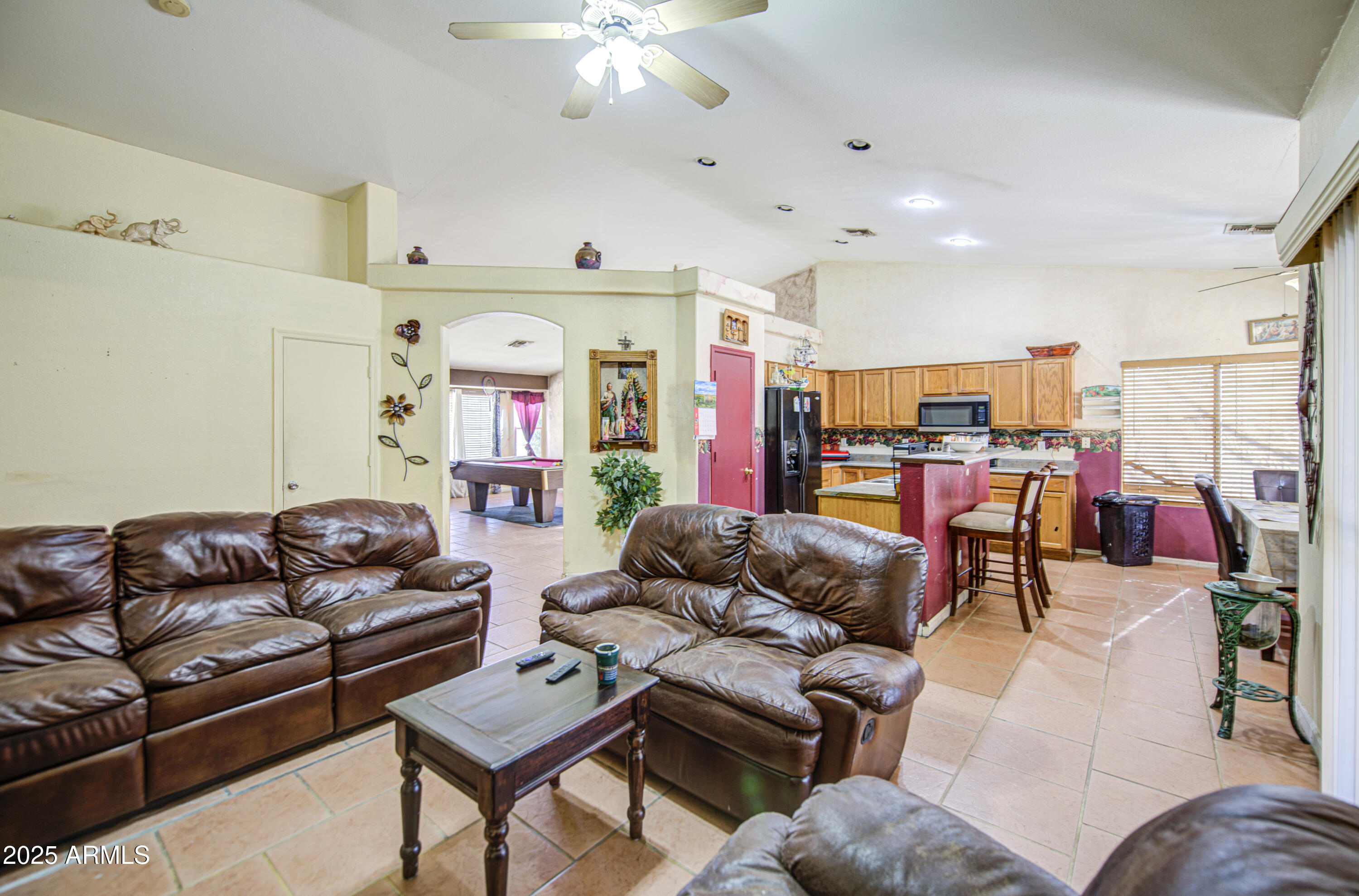 8530 West Berkeley Road Phoenix, AZ 85037 - Photo 12 of 48 a living room with furniture kitchen view and a chandelier
