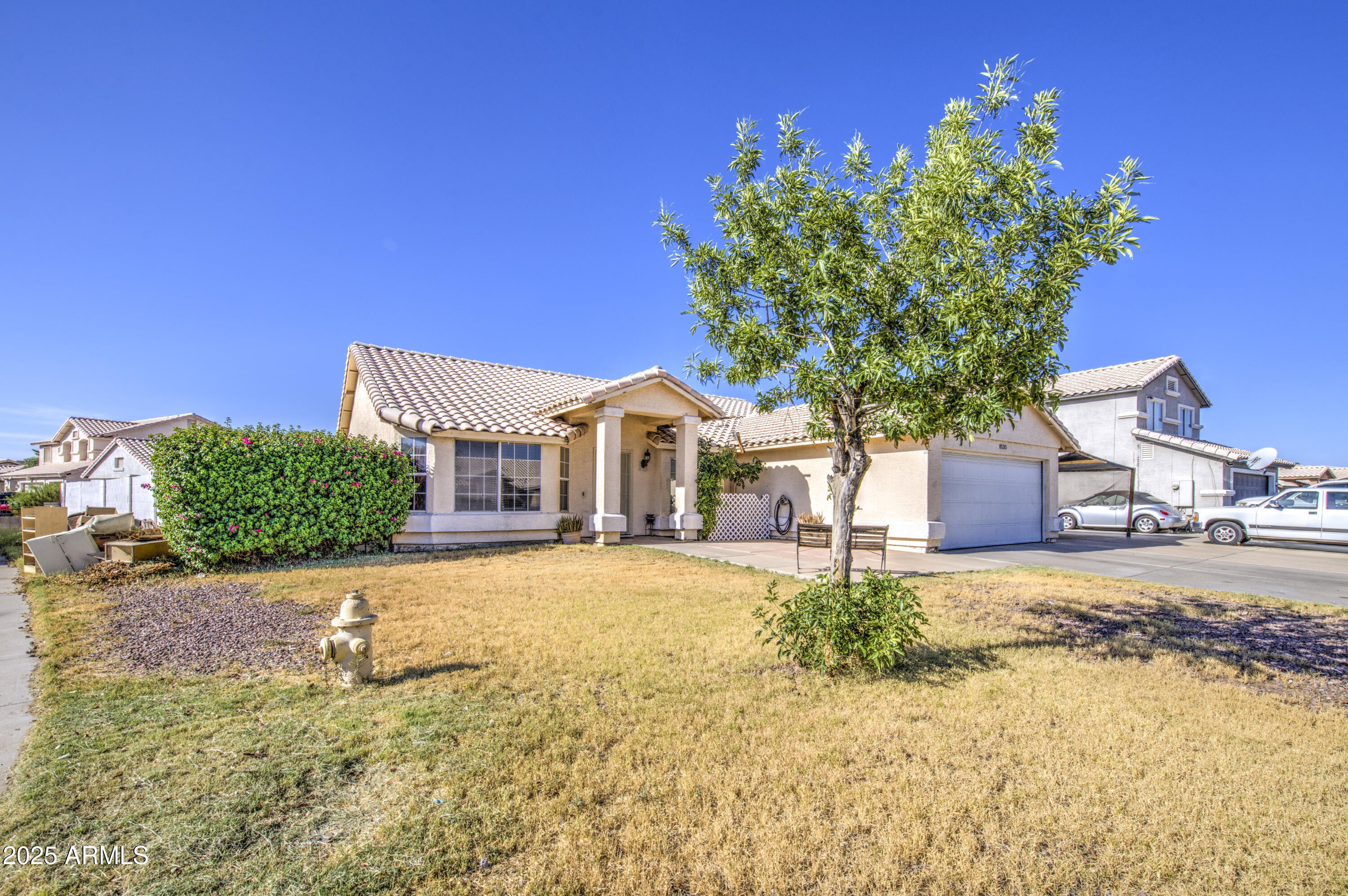 8530 West Berkeley Road Phoenix, AZ 85037 - Photo 2 of 48 a front view of a house with a yard and garage