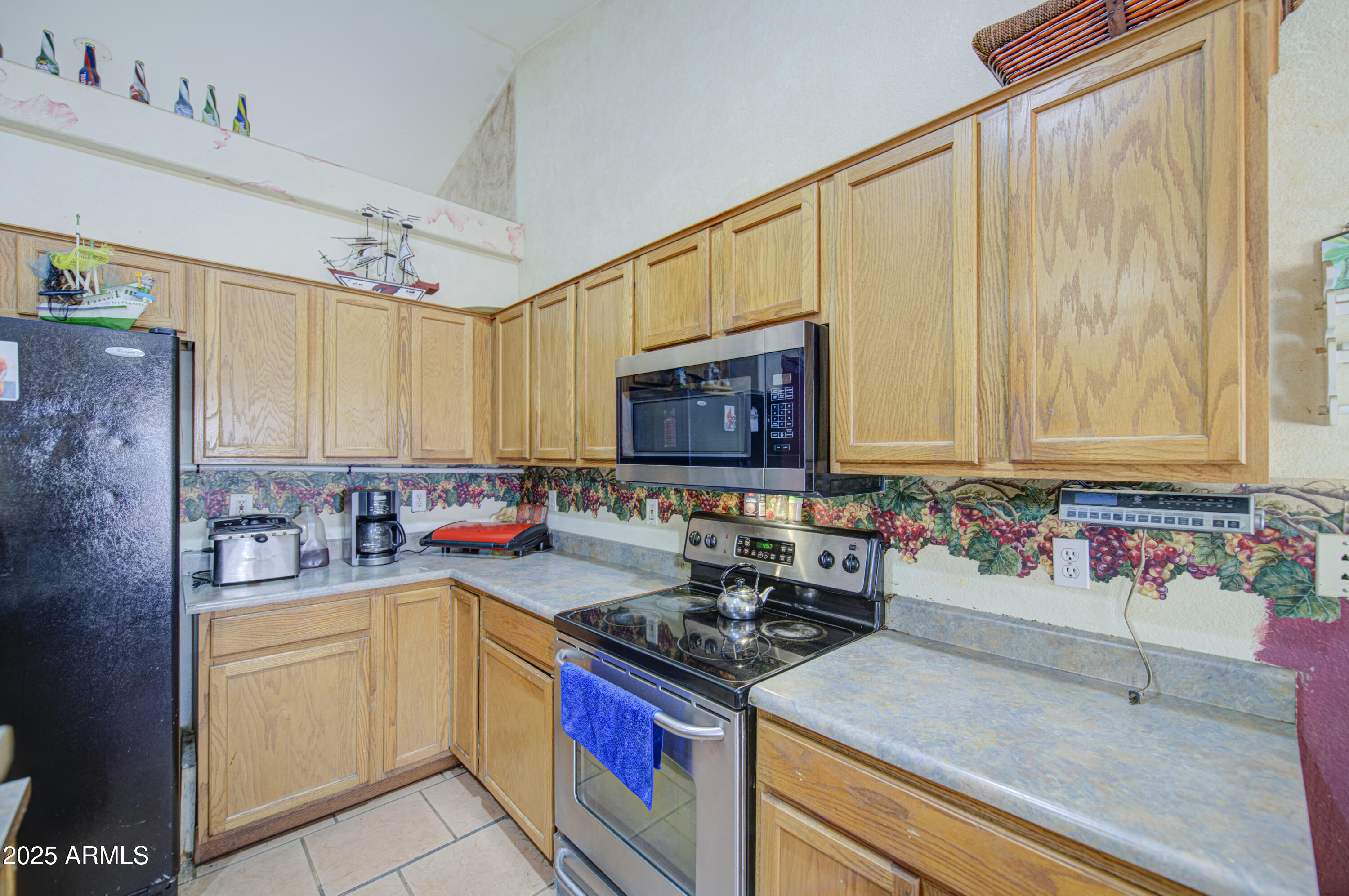 8530 West Berkeley Road Phoenix, AZ 85037 - Photo 21 of 48 a kitchen with stainless steel appliances granite countertop a sink stove and cabinets
