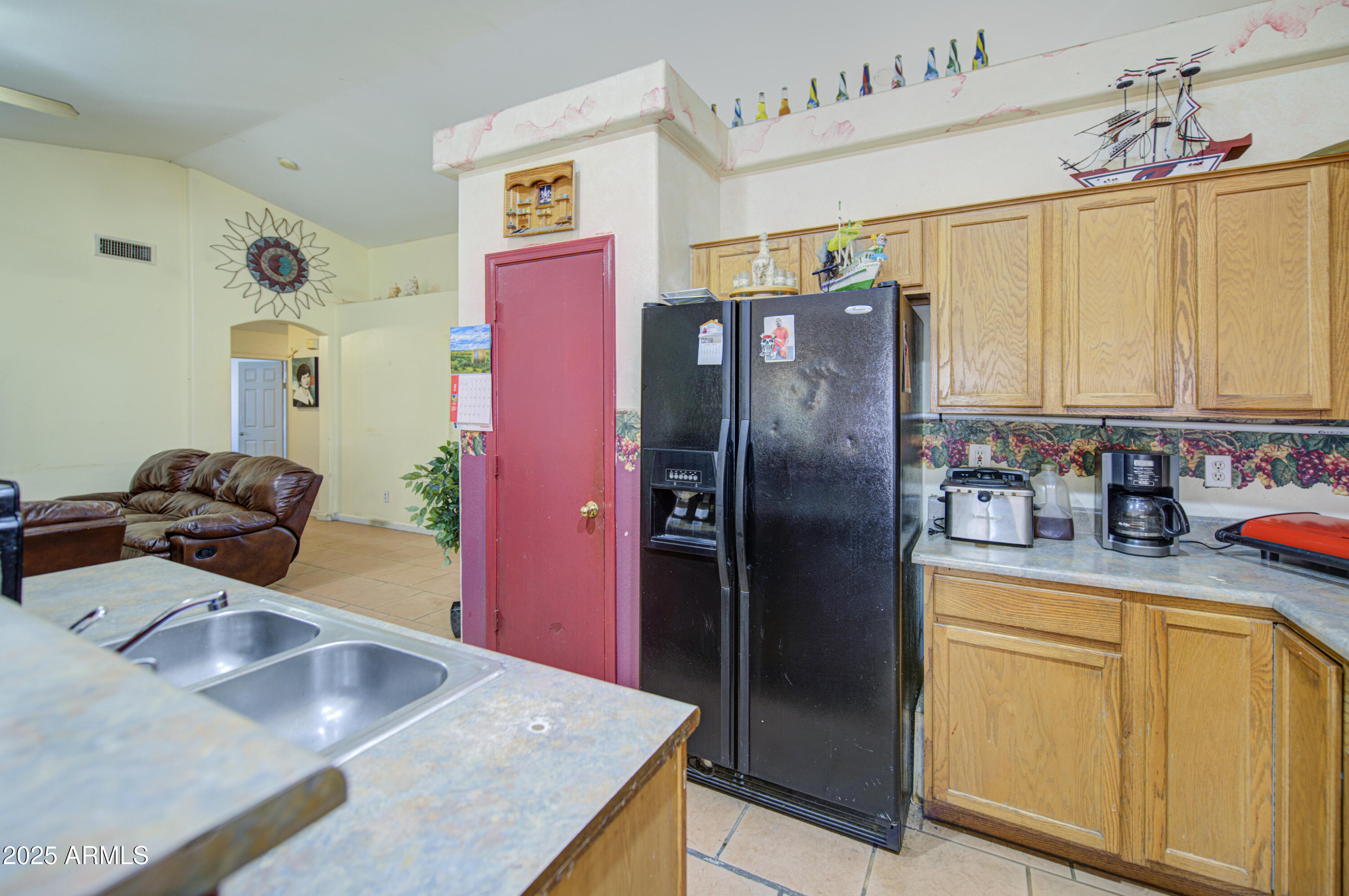8530 West Berkeley Road Phoenix, AZ 85037 - Photo 22 of 48 a kitchen with stainless steel appliances granite countertop a refrigerator a sink and white cabinets
