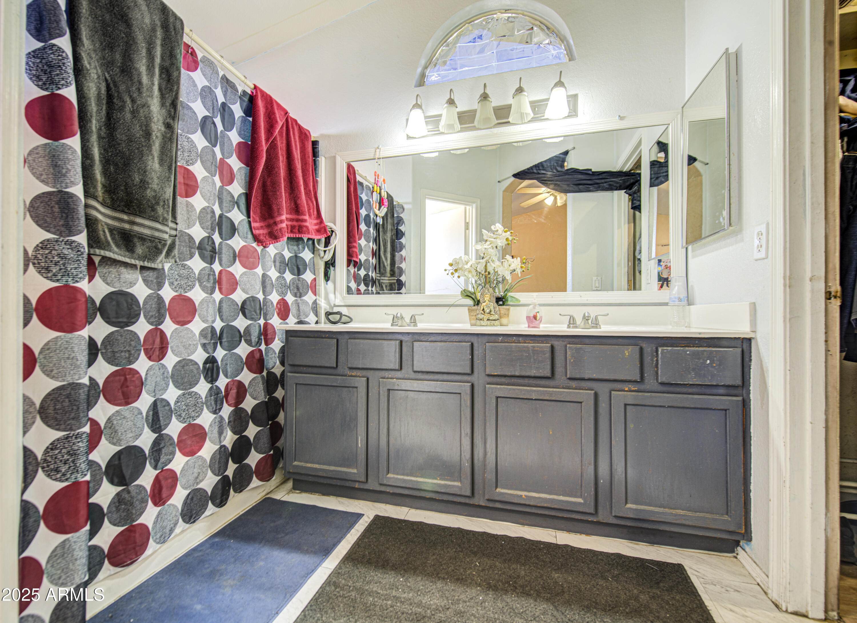 8530 West Berkeley Road Phoenix, AZ 85037 - Photo 28 of 48 a bathroom with a sink and a mirror