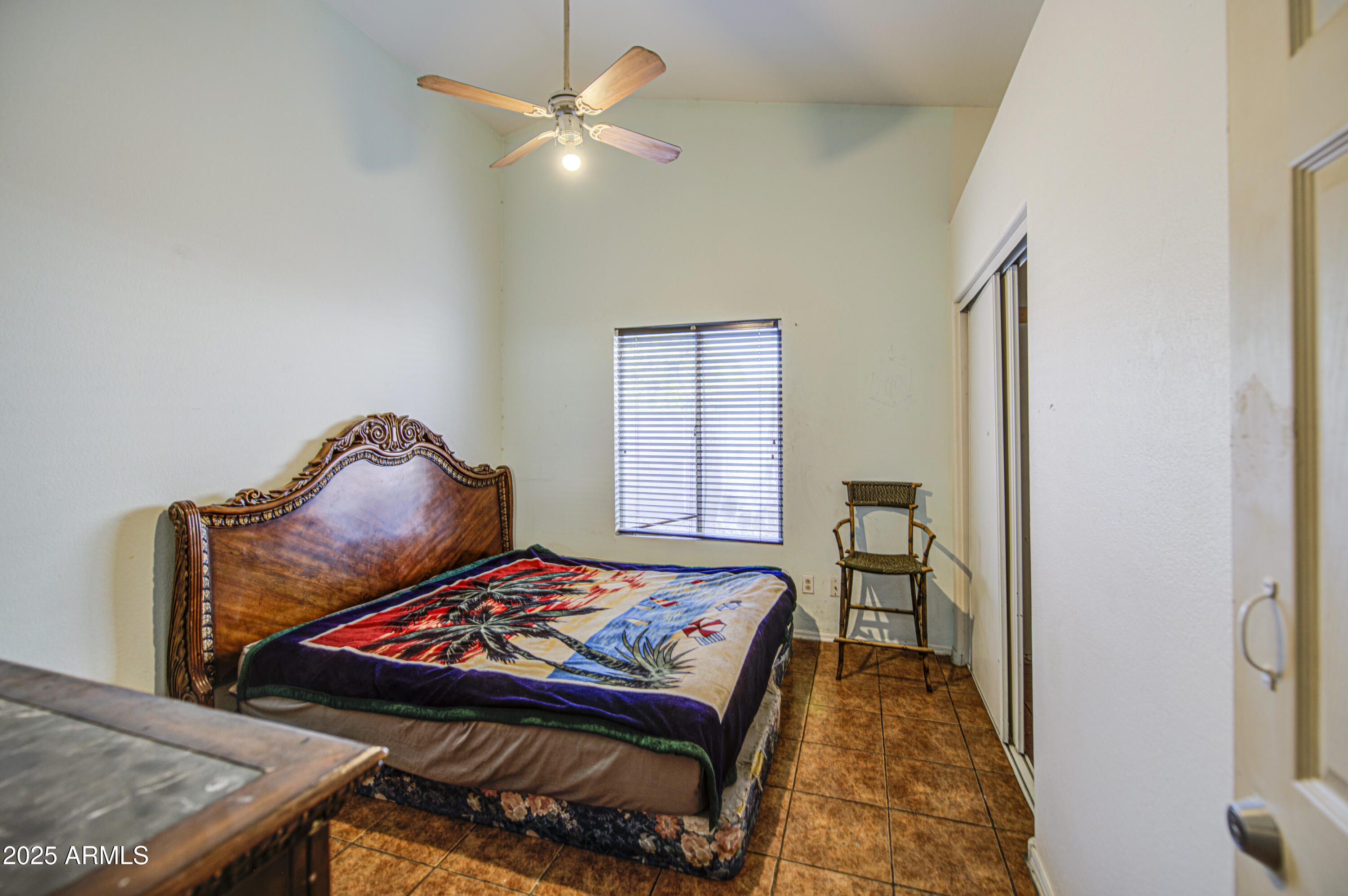 8530 West Berkeley Road Phoenix, AZ 85037 - Photo 31 of 48 a bedroom with a bed and a chandelier