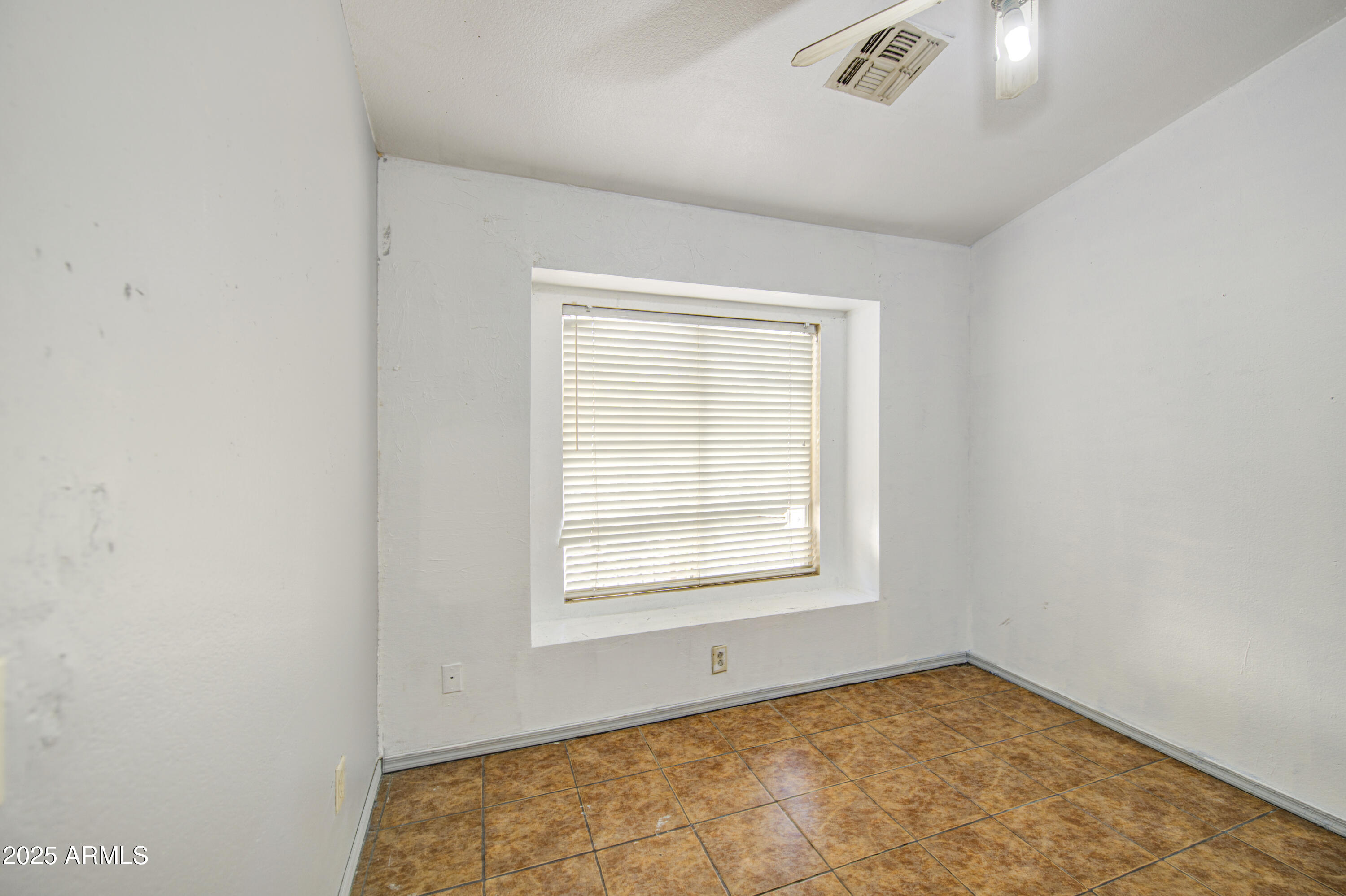 8530 West Berkeley Road Phoenix, AZ 85037 - Photo 35 of 48 an empty room with a window