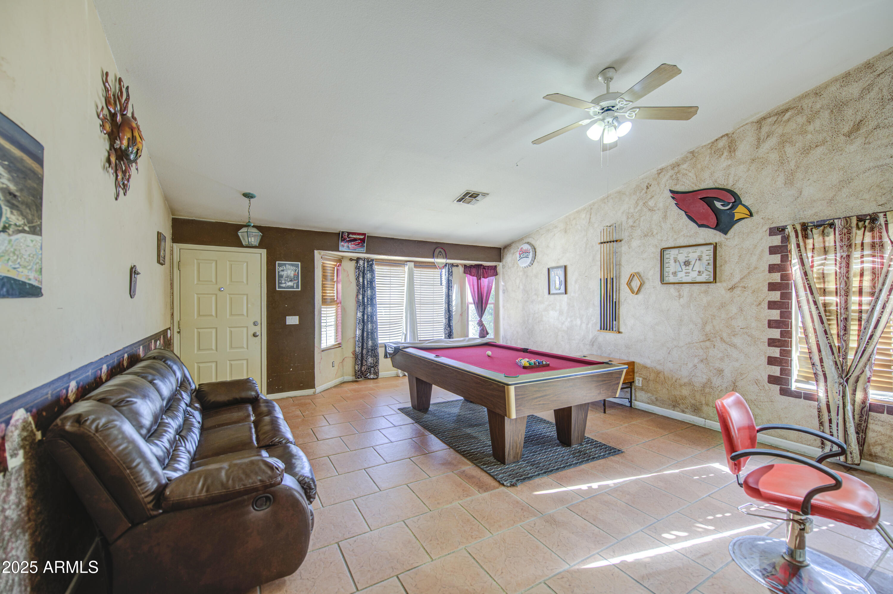 8530 West Berkeley Road Phoenix, AZ 85037 - Photo 9 of 48 a living room with furniture a rug and a chandelier