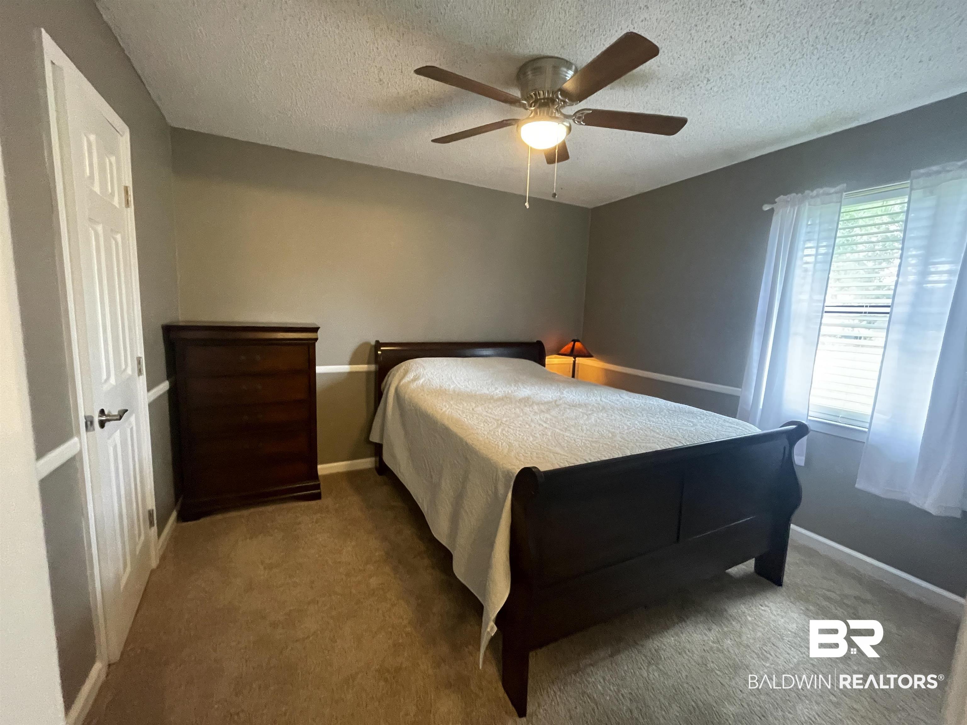 2274 Foshee Road Brewton, AL 36426 - Photo 12 of 23 Bedroom featuring a textured ceiling, carpet flooring, and ceiling fan