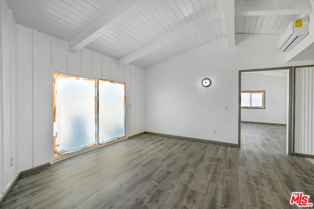 37170 Rabbit Springs Road Lucerne Valley, CA 92356 - Photo 3 of 10 a view of an empty room with glass door and wooden floor