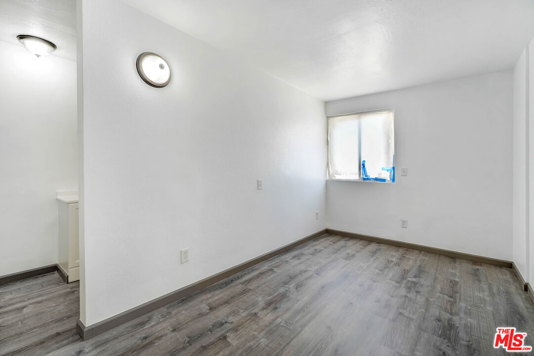 37170 Rabbit Springs Road Lucerne Valley, CA 92356 - Photo 7 of 10 an empty room with wooden floor and windows