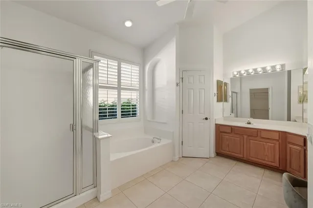 a spacious bathroom with a tub shower and sink