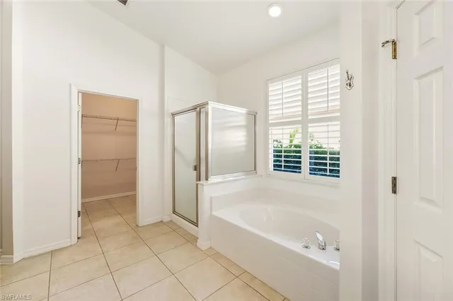 a bathroom with a bathtub and shower