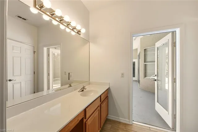 a bathroom with a sink a mirror and a shower
