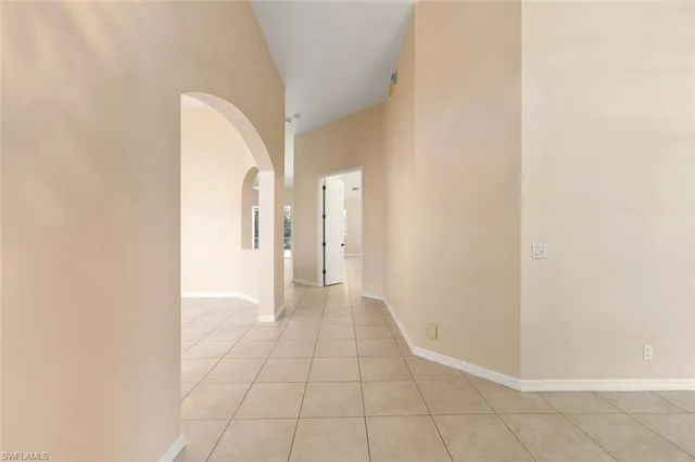 a view of a room with an empty space and a window