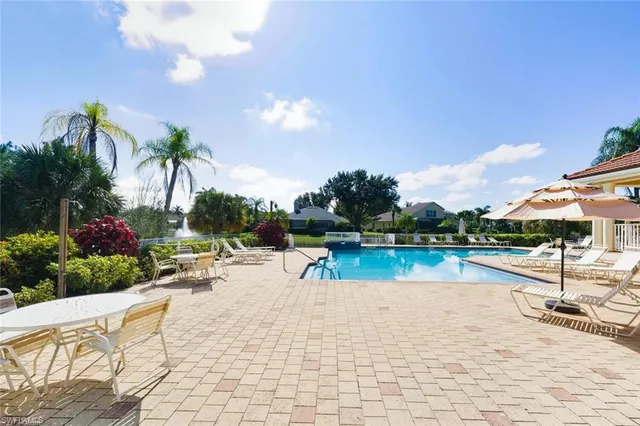 a view of swimming pool with sitting area