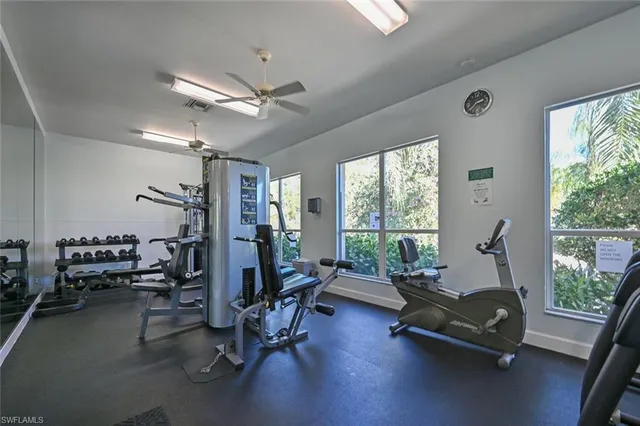 a living room with furniture gym equipment and a large window