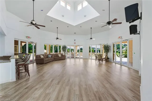 a living room with lots of furniture and a wooden floor