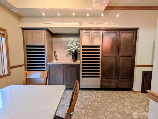 a kitchen with kitchen island a refrigerator and a sink