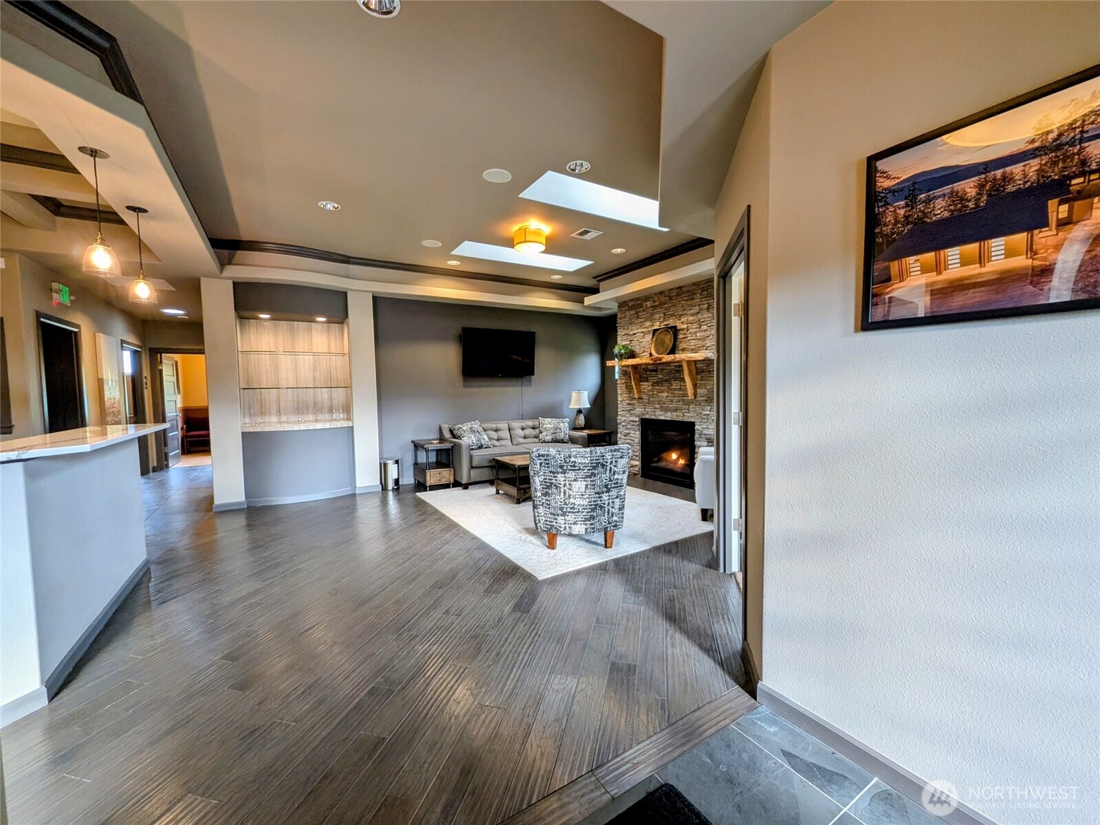 259003 Highway 101, Unit B Sequim, WA 98382 - Photo 4 of 21 a kitchen with stainless steel appliances granite countertop a refrigerator a sink dishwasher a stove and a dining table with wooden floor