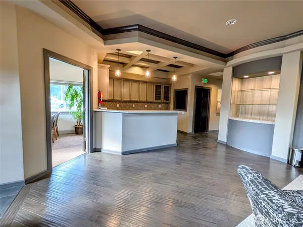a view of kitchen with furniture and wooden floor