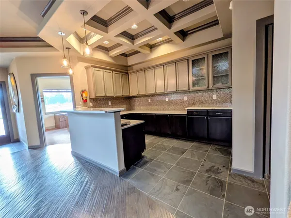 a kitchen with granite countertop a sink and cabinets