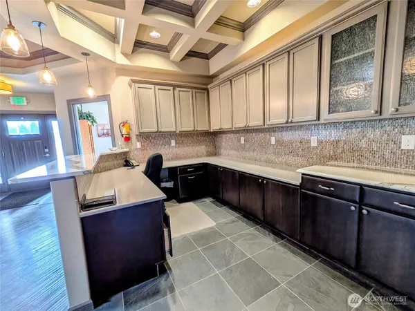 a kitchen with a sink a counter top space and cabinets