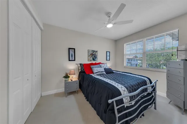 a bed room with a bed and a large window