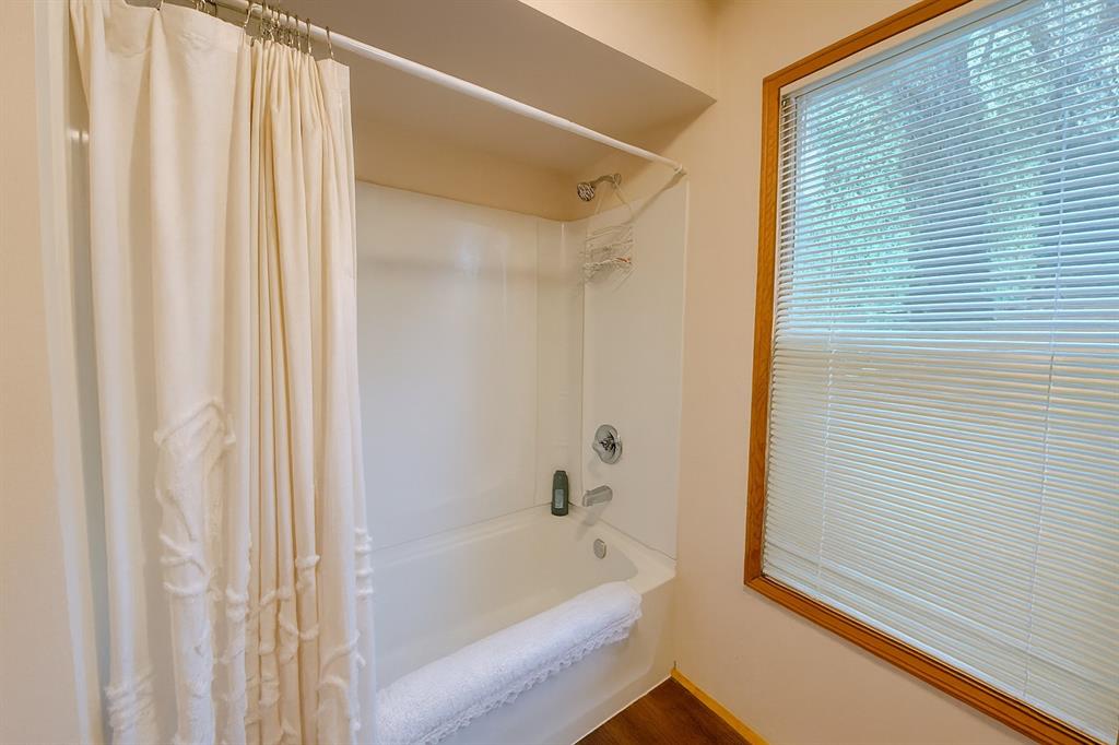 314 Cockerell Street Eustace, TX 75124 - Photo 11 of 15 a bathroom with a bathtub and shower