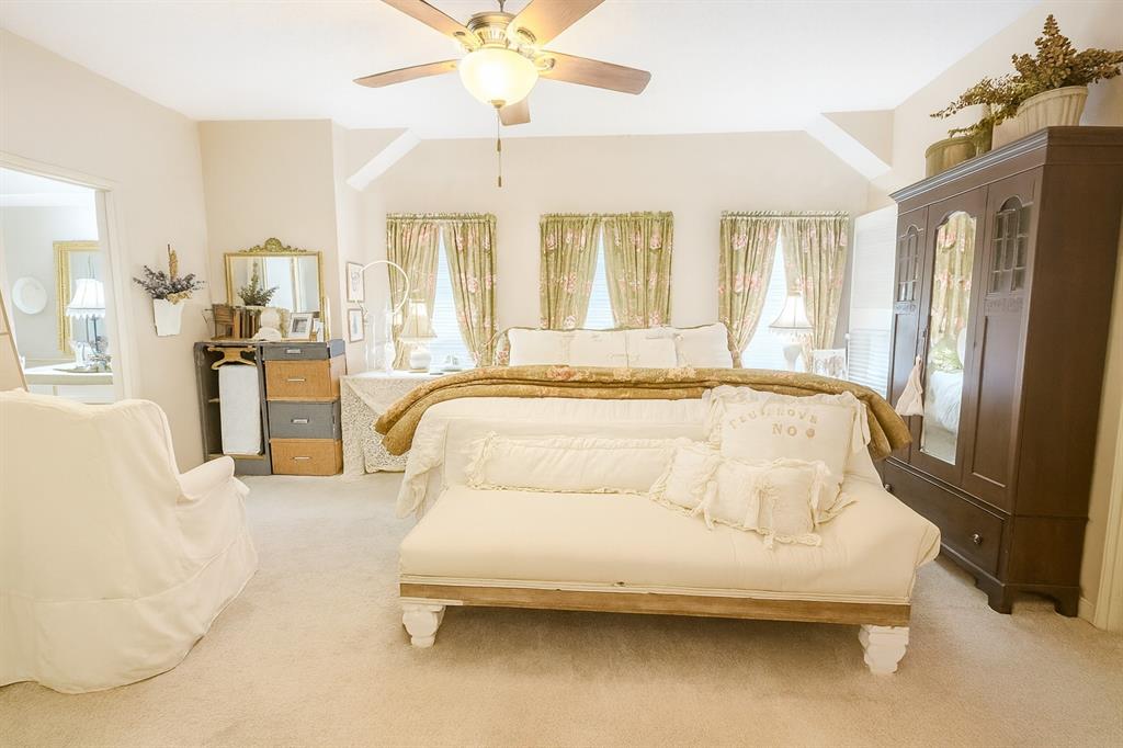 314 Cockerell Street Eustace, TX 75124 - Photo 4 of 15 a spacious bedroom with a bed and a chandelier
