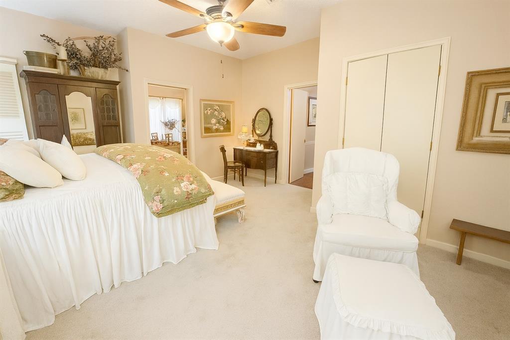 314 Cockerell Street Eustace, TX 75124 - Photo 5 of 15 a bedroom with a bed a mirror and a chandelier