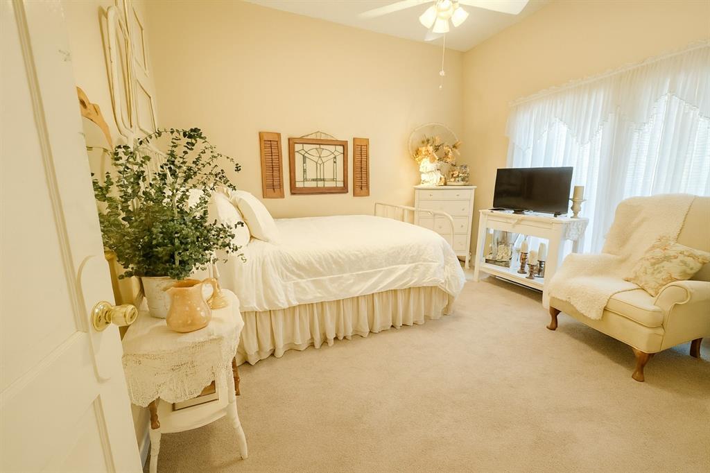 314 Cockerell Street Eustace, TX 75124 - Photo 8 of 15 a bed room with a bed and a chair