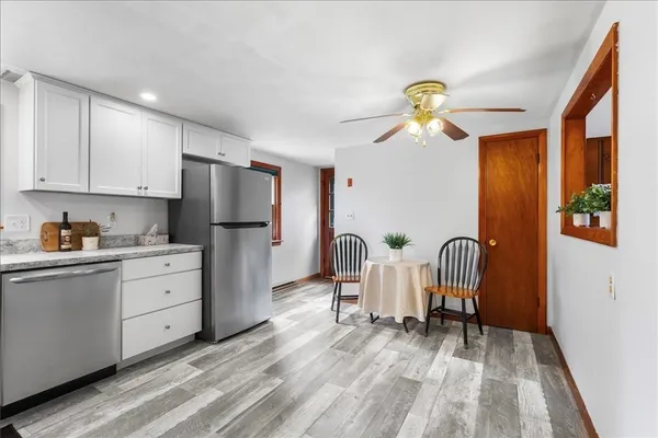 a kitchen with furniture a refrigerator and a sink