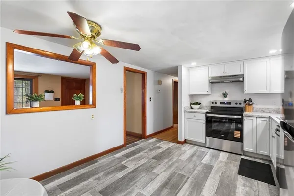a kitchen with a refrigerator and a stove top oven