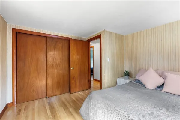 a bedroom with a bed and a night stand