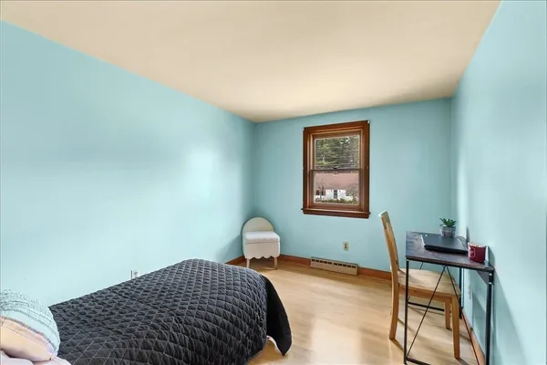 a bedroom with a bed and a window