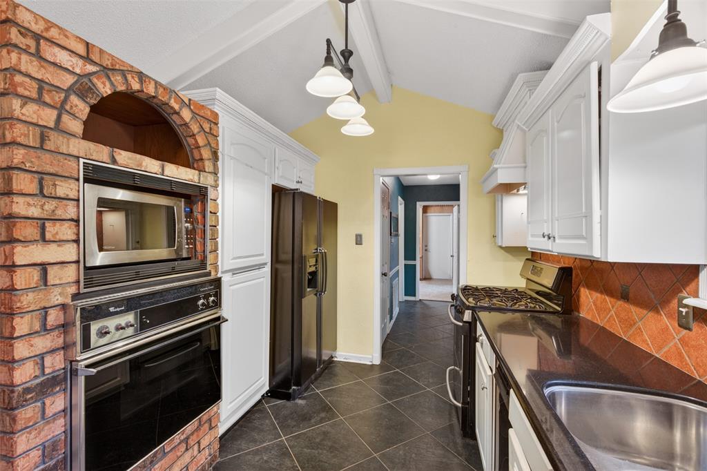 401 Cane Bend Drive Haughton, LA 71037 - Photo 4 of 27 a kitchen with stainless steel appliances granite countertop a sink a stove and a refrigerator