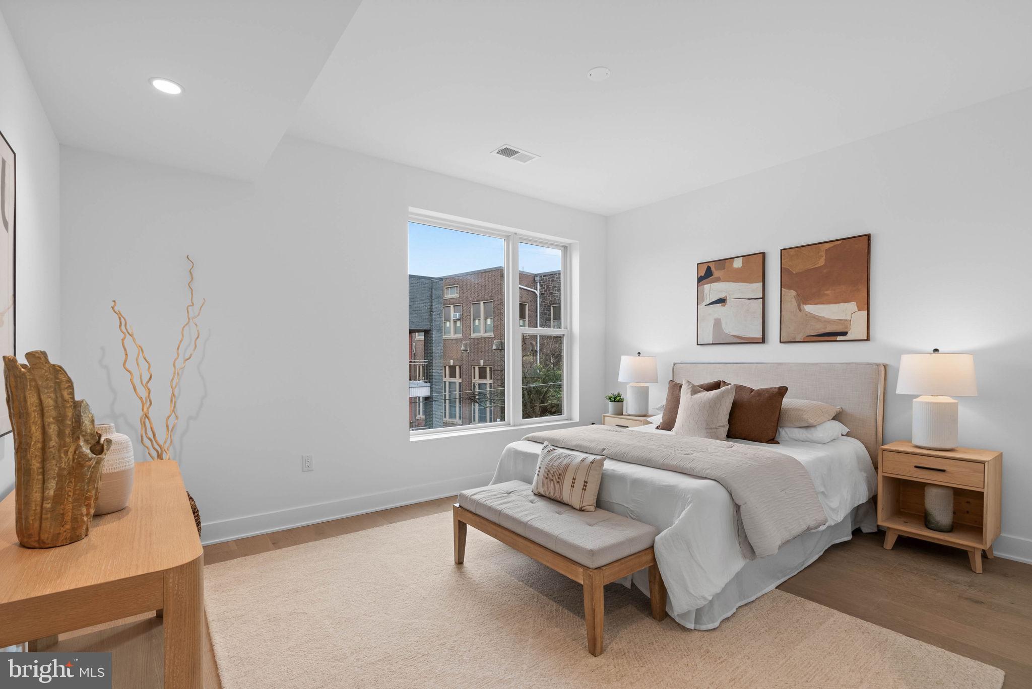 650 Fairmount Avenue, Unit I3 Philadelphia, PA 19123 - Photo 23 of 42 a bedroom with a bed a table and painting