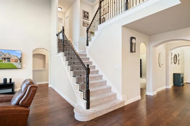 a view of a dining room with furniture wooden floor and chandelier