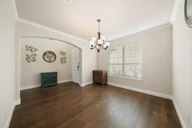 a kitchen with a refrigerator and a dining table
