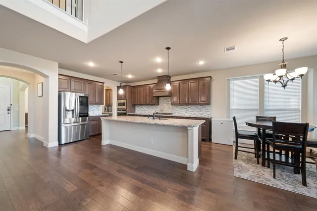 a bathroom with a granite countertop shower and a sink