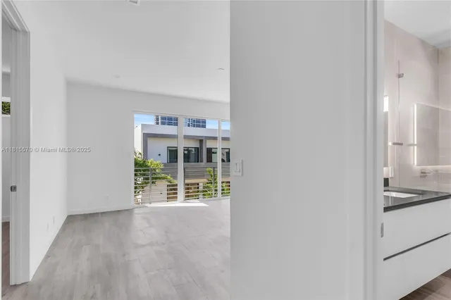 a view of an empty room and wooden floor