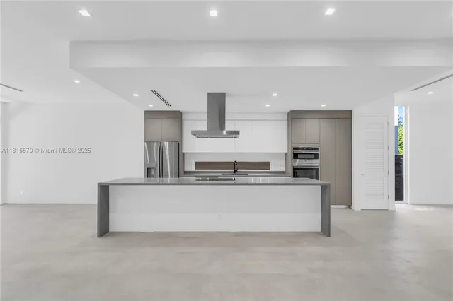 a large kitchen with stainless steel appliances